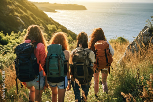 A group of backpacking friends on vacation while hiking in the countryside by the sea