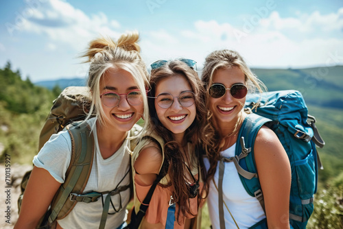 Portrait of friends with backpacks on vacation, relaxing while hiking in the countryside