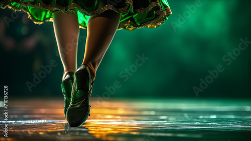 Irish dancing legs close up on stage on bright green lighting stage background with copy space, concept of St Patrick celebration, ethnic dancing event. photo