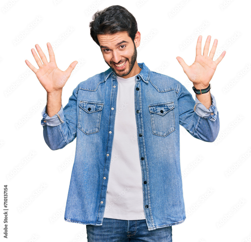Young hispanic man wearing casual clothes showing and pointing up with fingers number ten while smiling confident and happy.