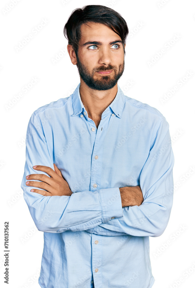 Hispanic man with blue eyes with arms crossed gesture smiling looking to the side and staring away thinking. Hispanic man with blue eyes with arms crossed gesture smiling looking to the side and staring away thinking.