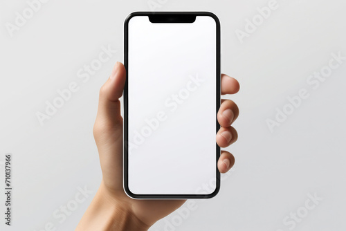 Hand holding phone with white screen. Can be used for technology or communication concepts.