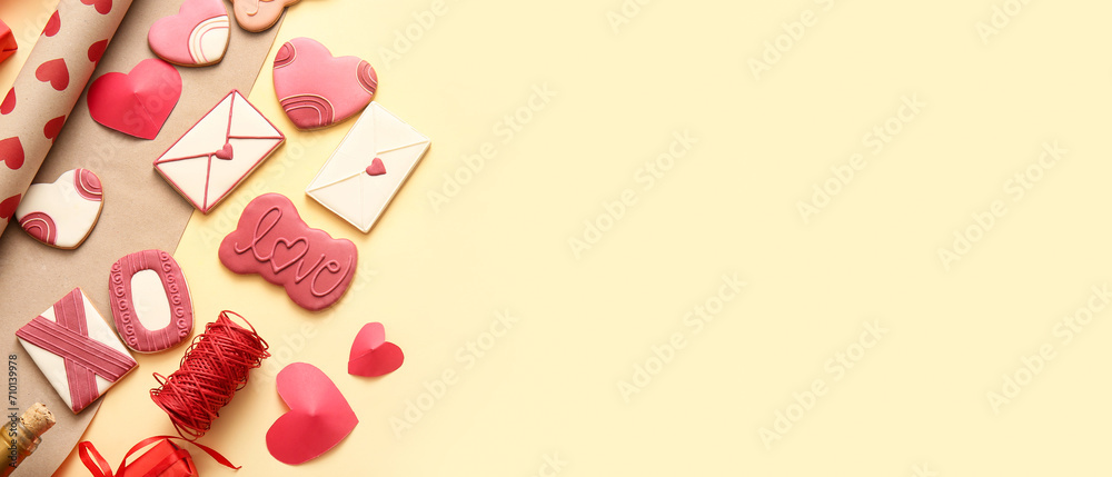 Sweet cookies with decor on yellow background with space for text. Valentine's Day celebration