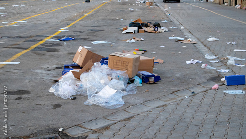 Lots of trash and litter scattered on the street photo