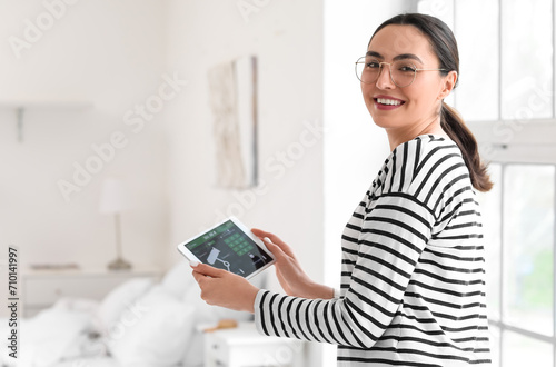 Smiling woman using smart h...