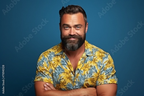 Portrait of a handsome man with a beard and mustache over blue background