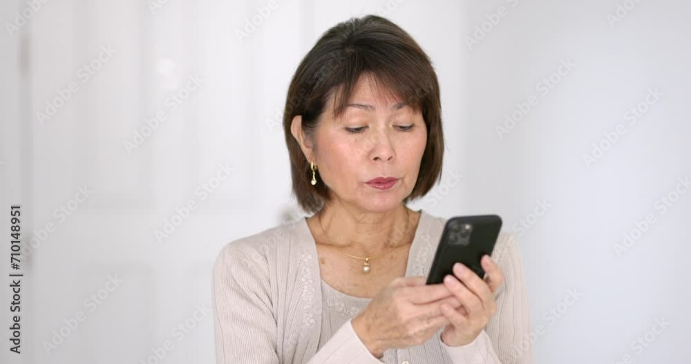 Portrait attractive woman enjoying texting reading email messages on mobile cell phone isolated in bright room closeup. Portrait attractive woman enjoying texting reading email messages on mobile cell phone isolated in bright room closeup.