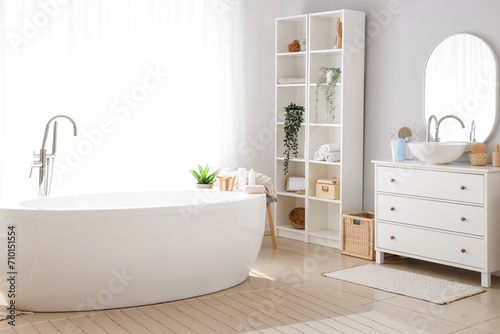 Stylish interior of bathroom with bathtub