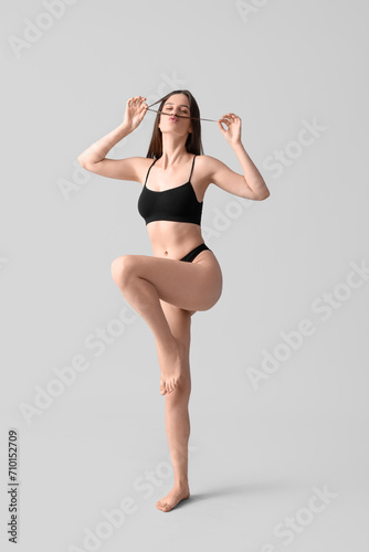 Body positive woman in underwear on light background