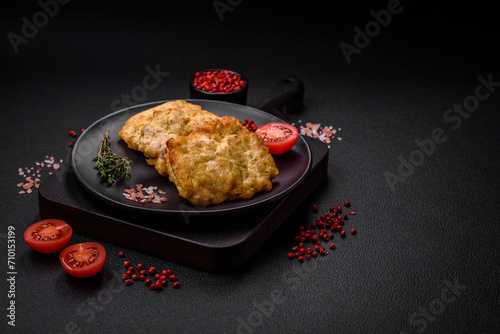 Delicious juicy fried chicken or pork pancakes with salt, spices and herbs