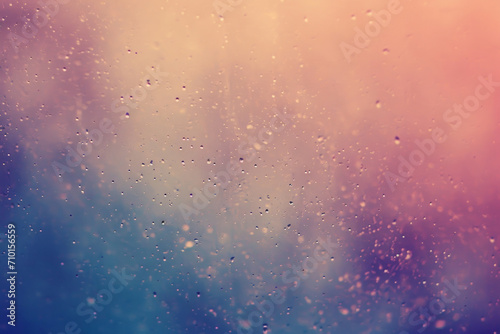 Raindrops on a window with a blurred pink and blue gradient background  conveying a calm  rainy day atmosphere.