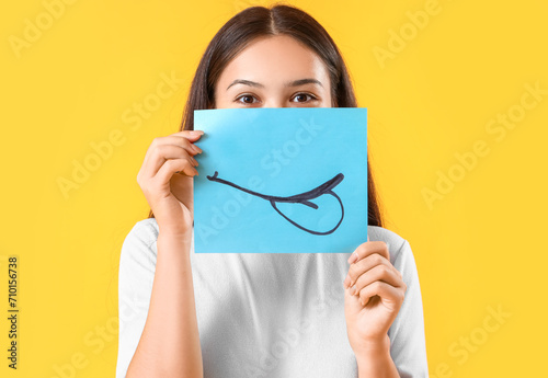 Young Asian woman with pape...
