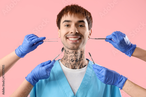 Male dentist and hands with...