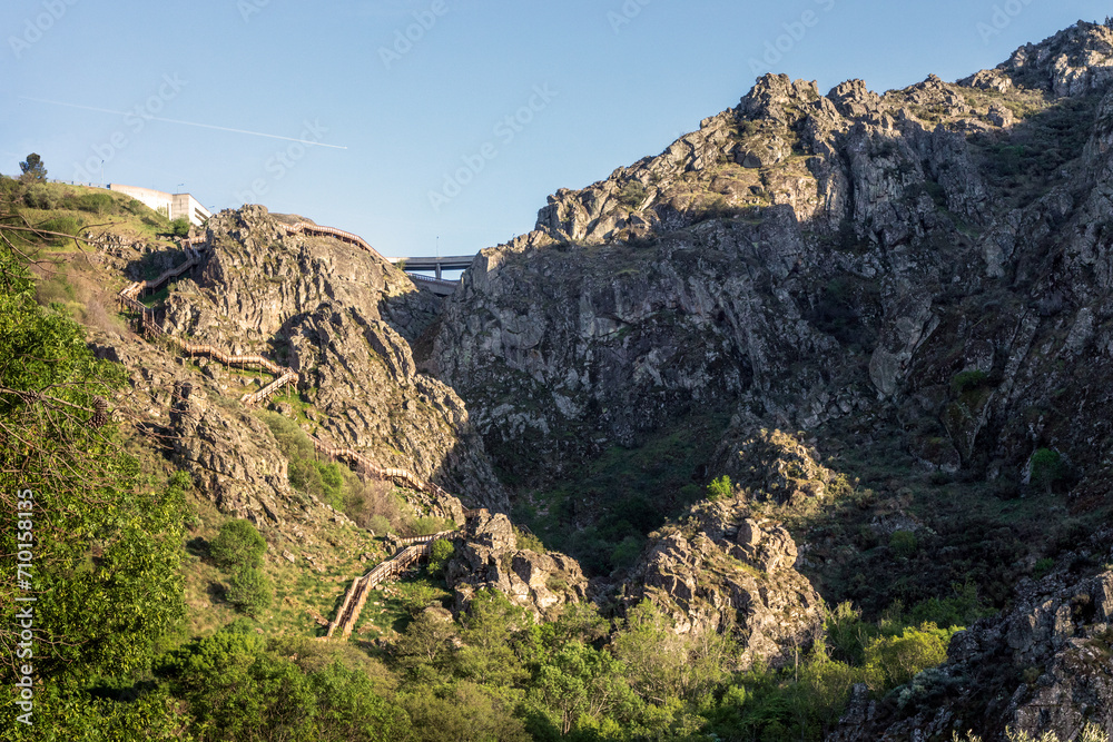 View of the Caldeirão dam in Guarda, Portugal, with the Mondego walkways winding up the rocky mountainside.