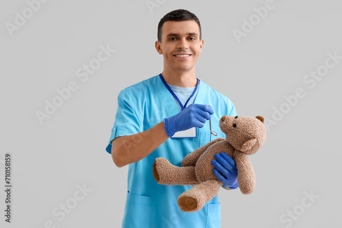 Young male dentist with pro...