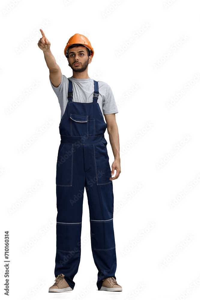 A builder male on a white background points to the side A builder male on a white background points to the side