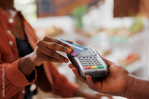 Canvastavla Black person using credit card to make contactless payment for fresh organic produce at a local market