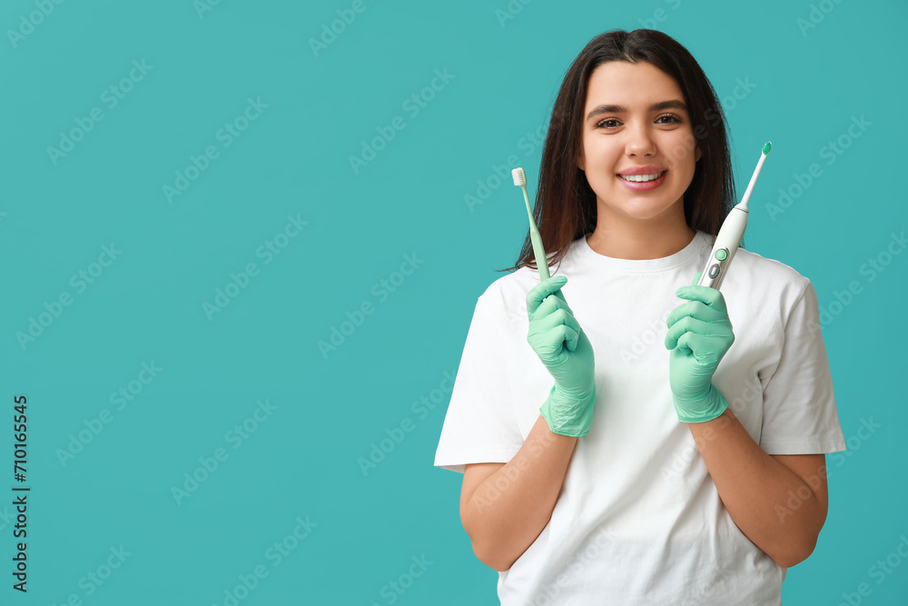 Female dentist with toothbrushes on blue background. World Dentist Day Female dentist with toothbrushes on blue background. World Dentist Day