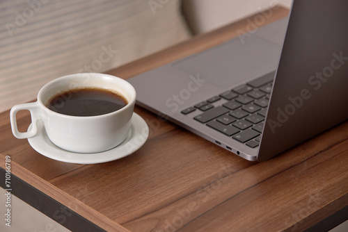 Coffee and laptop on table