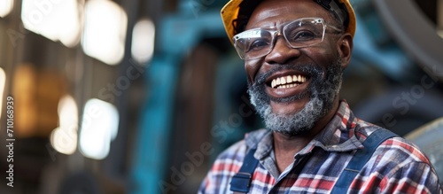 Grinning African American industrial specialist in metal construction.