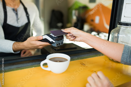 Customer paying for her coffee with a credit card