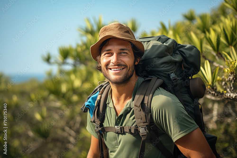 Smiling Man with Backpack and Binoculars on Mountain Background