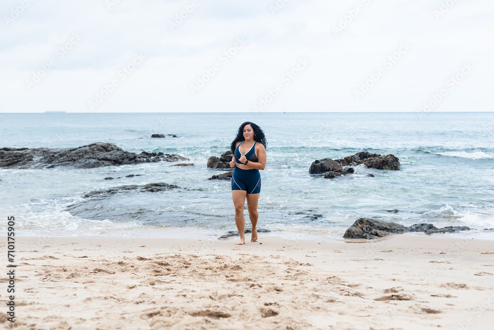 Fitness woman, athlete, doing exercises on the beach running towards the camera. Fitness woman, athlete, doing exercises on the beach running towards the camera.