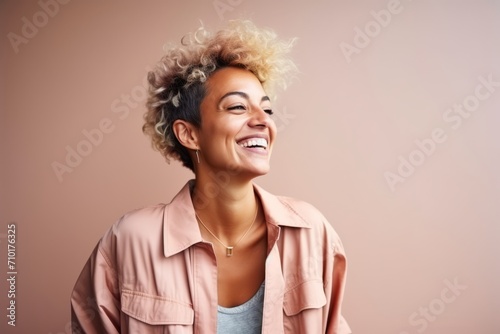 Portrait of a beautiful young african american woman smiling against pink background