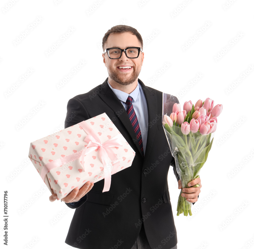 Handsome businessman with tulips and gift box on white background. International Women's Day celebration Handsome businessman with tulips and gift box on white background. International Women's Day celebration