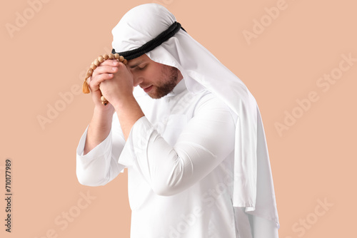 Young Muslim man praying on...