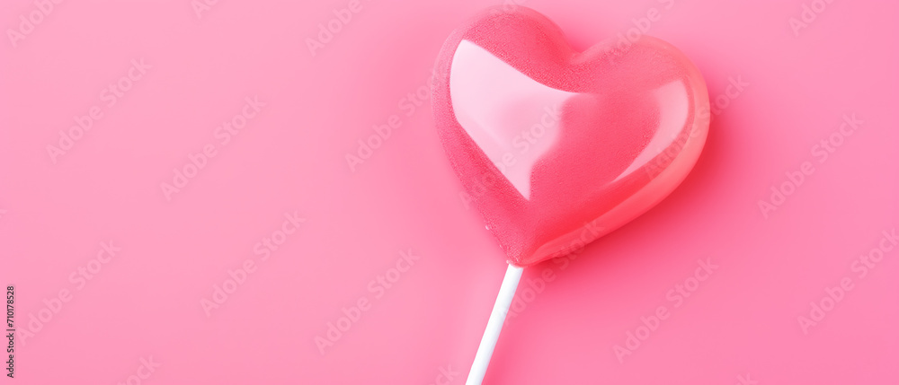 heart-shaped lollipop on a pink background on the day of love and friendship