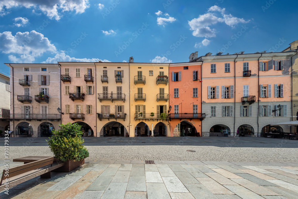 Obraz premium Cuneo, Piedmont, Italy - August 16, 2023: Cityscape on Via Roma, main cobblestone pedestrian street with colorful old buildings and with arcade in historic center