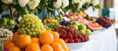 A buffet table showing various fruits on a white tablecloth, creating an elegant ambiance.