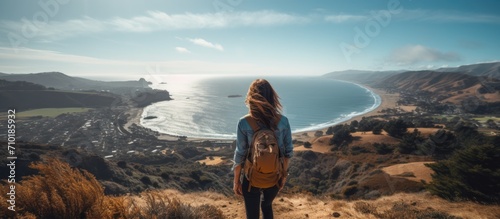 Hiking girl overlooking ocean view - Follow me - POV.