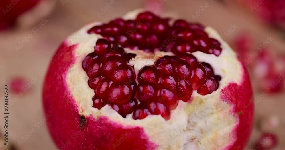 red ripe pomegranate with red grains, open pomegranate fruit on the table red ripe pomegranate with red grains, open pomegranate fruit on the table