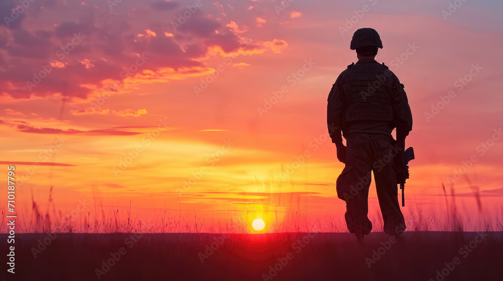 Silhouette of soldier standing against the backdrop of a sunset. Greeting card for Veterans Day