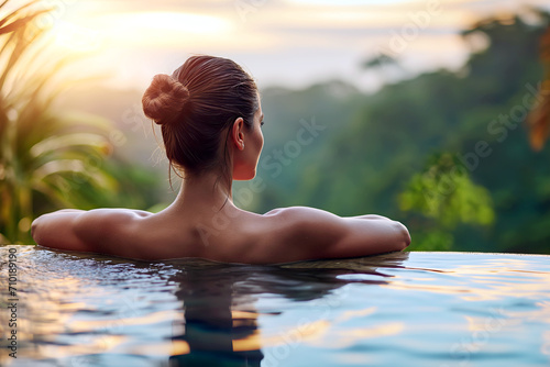 Woman Sitting in Pool With Back to Camera © Nedrofly