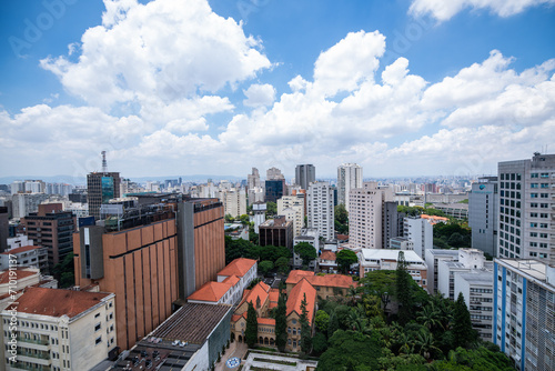 View of the skyline of S  o Paulo  Brazil from the SESC Avenida Paulista biuilding on a partly cloudy day