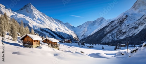 Snow-covered ski huts in a winter landscape. Alpine cabins in Aosta Valley Monterosa Gressoney.