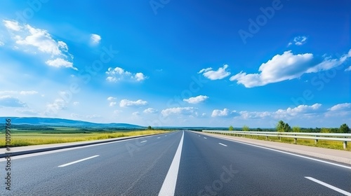 highway in the grassland background of blue sky and bright clouds, long road stretches into the distance. empty street on a beautiful sunny day © @_ greta