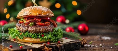 Christmas-themed wooden board showcasing a homemade burger made with black angus beef and fresh veggies.