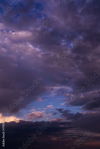 Epic dramatic sunrise, sunset pink violet blue sky with dark storm clouds background texture
