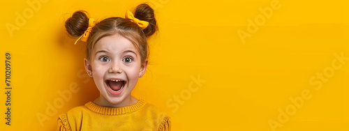 child smiling on a yellow studio background