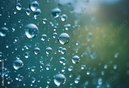 Beautiful large transparent water drops or rain water on blue soft background macro with mirror refl