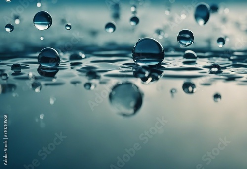 Beautiful large transparent water drops or rain water on blue soft background macro with mirror refl