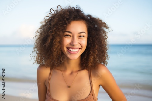 Bi-racial young woman smiling at beach