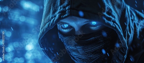 Close-up of a masked cyber criminal staring at the camera.