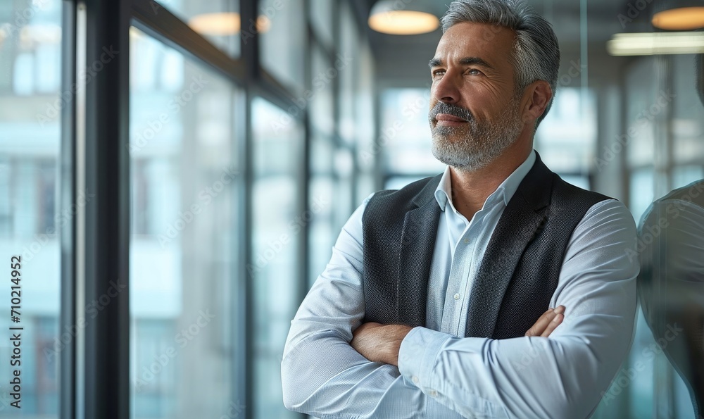 Happy mid aged older professional business man, mature latin executive manager, 50 years old investor standing in office arms crossed leaning at glass, Generative AI Happy mid aged older professional business man, mature latin executive manager, 50 years old investor standing in office arms crossed leaning at glass, Generative AI