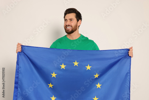 Man with flag of European Union on white background