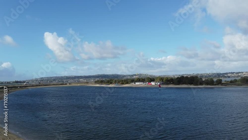 San Diego Travel And Tourism; Fiesta Island Park In Mission Bay, California; Low Aerial Ascend From Shoreline Approaching A Kite Surfer.
